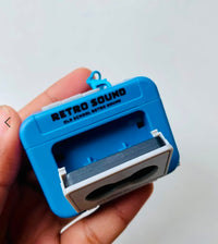 Retro Sound Cassette Keychain held in hand - Red